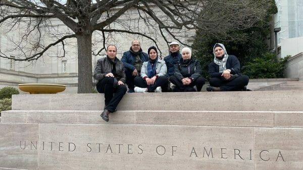 group of Jordanians in front of USA sign