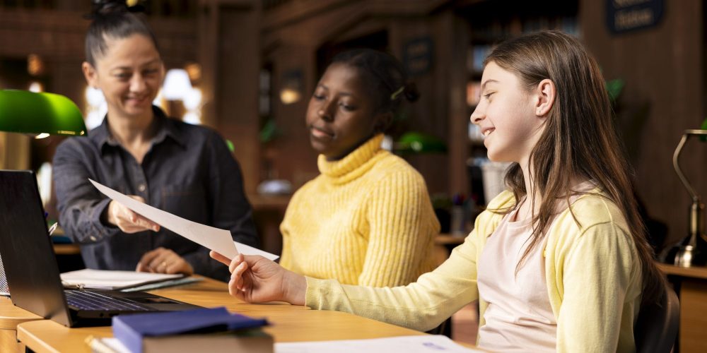 tutor-providing-learning-materials-academic-session-with-schoolgirls